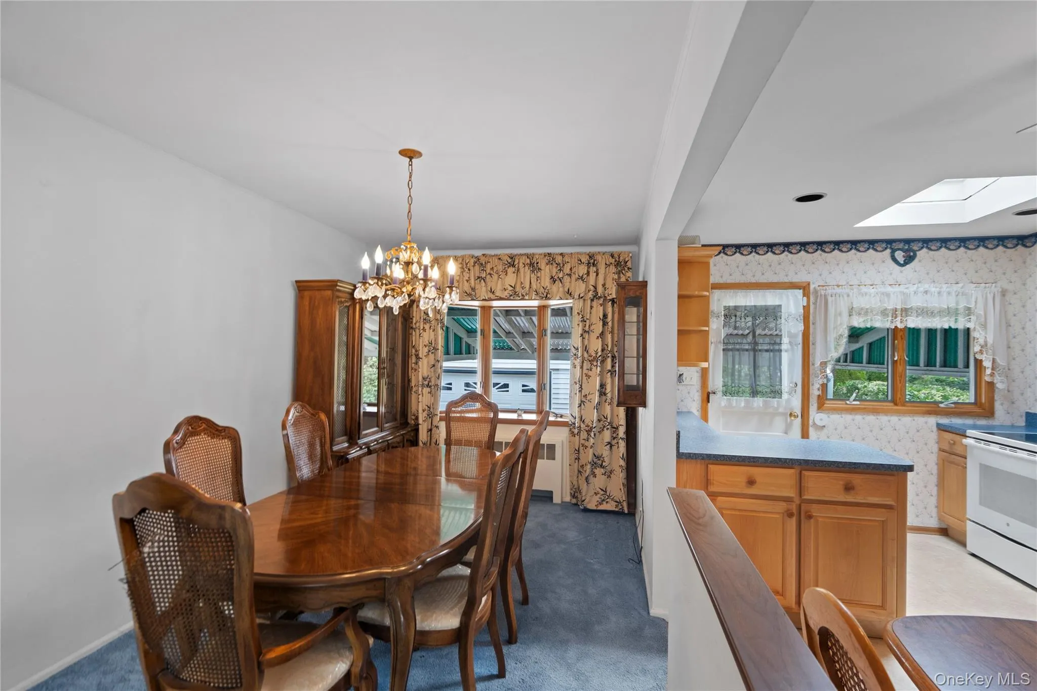 Dining area featuring a chandelier, wood-finish flooring, and built-in cabinetry Dining area featuring a chandelier, wood-finish flooring, and built-in cabinetry