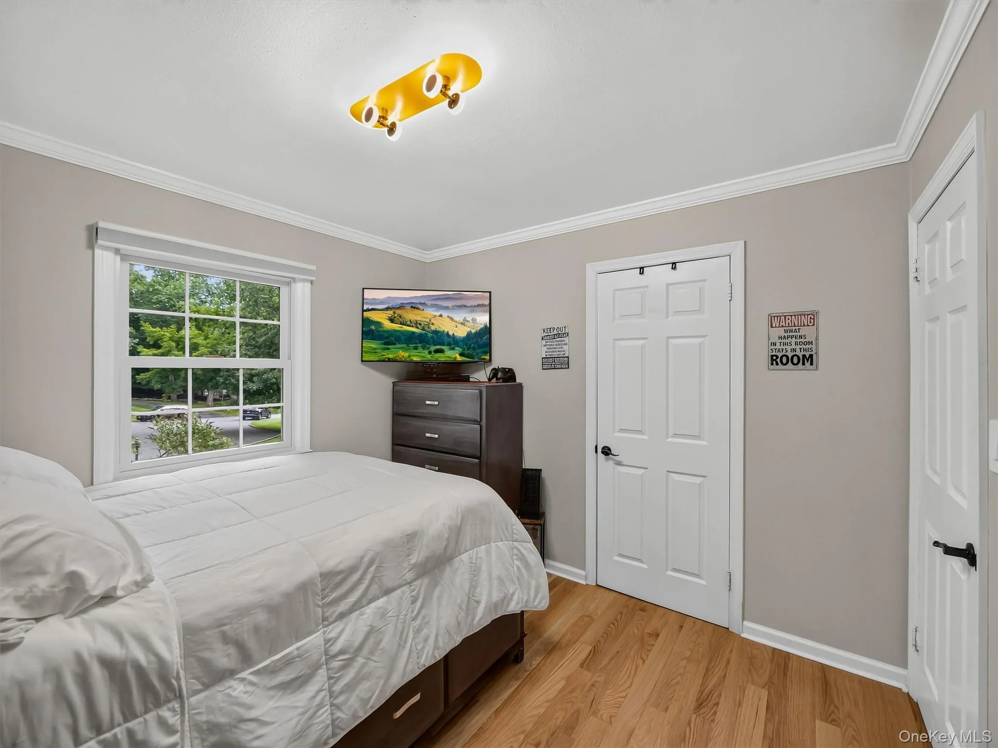 Hardwood flooring, light gray wall color, white trim, and a window with white casing Hardwood flooring, light gray wall color, white trim, and a window with white casing