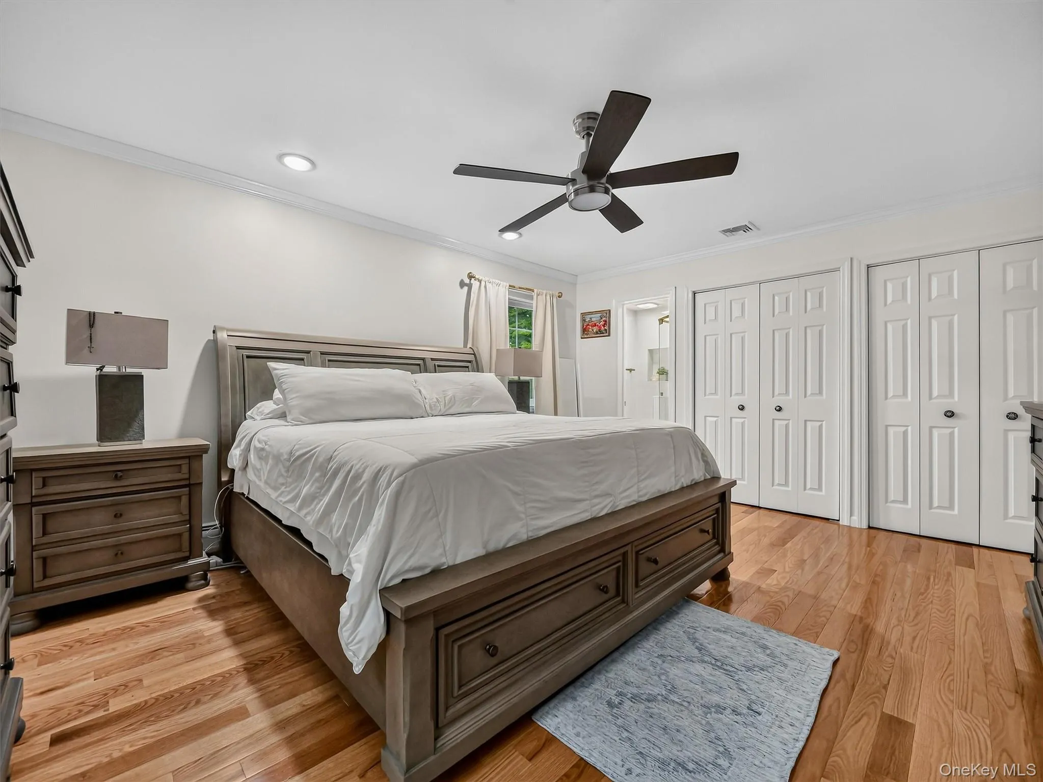 Hardwood flooring, recessed lighting, ceiling fan, crown molding, and bi-fold closet doors Hardwood flooring, recessed lighting, ceiling fan, crown molding, and bi-fold closet doors