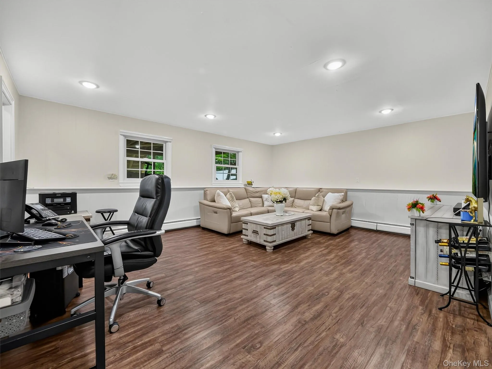 Recessed lighting, wood-finish flooring, two windows with gridded panes, and wainscoting Recessed lighting, wood-finish flooring, two windows with gridded panes, and wainscoting
