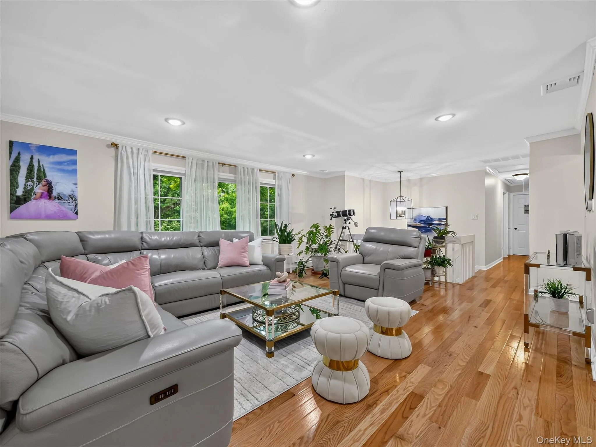 Hardwood flooring, recessed ceiling lighting, crown molding, multiple windows, and a ceiling-mounted light fixture Hardwood flooring, recessed ceiling lighting, crown molding, multiple windows, and a ceiling-mounted light fixture