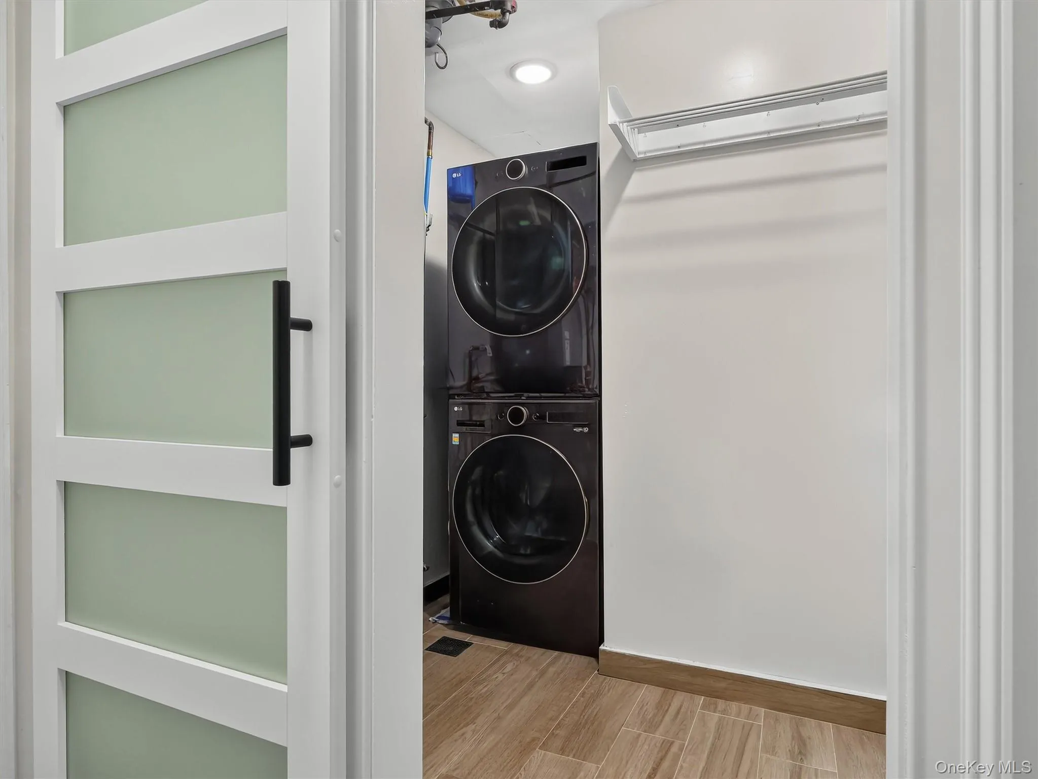 White barn interior door with frosted glass panels and a black pull handle to laundry White barn interior door with frosted glass panels and a black pull handle to laundry