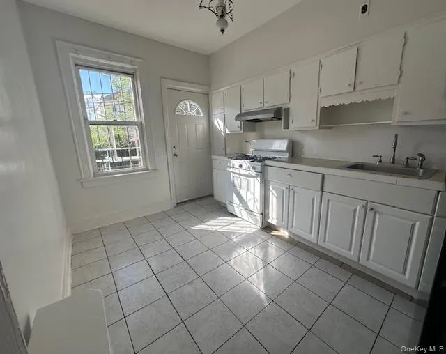 Kitchen with new appliances. Back door leading to porch and backyard Kitchen with new appliances. Back door leading to porch and backyard