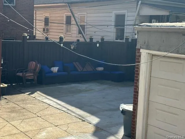 Backyard with couches and garage for storage only, no parking Backyard with couches and garage for storage only, no parking
