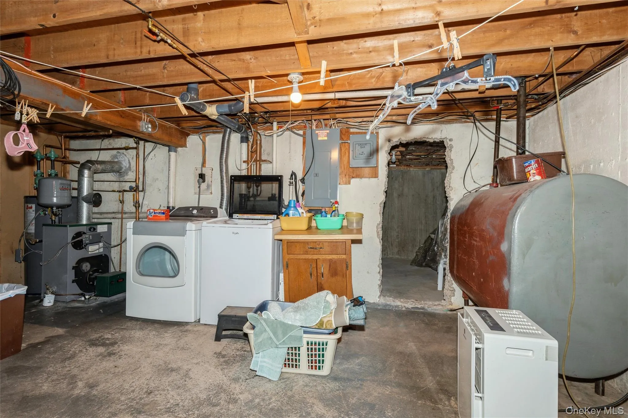 The laundry area and the inside oil tank are conveniently located and offer ideal access to the outside bilco door entrance, which is just beyond. The laundry area and the inside oil tank are conveniently located and offer ideal access to the outside bilco door entrance, which is just beyond.