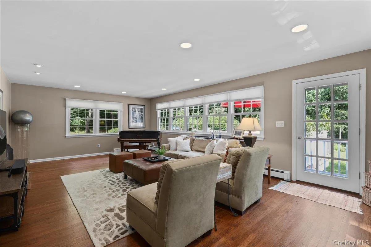 LR w/walls of windows and entry to side deck. LR w/walls of windows and entry to side deck.