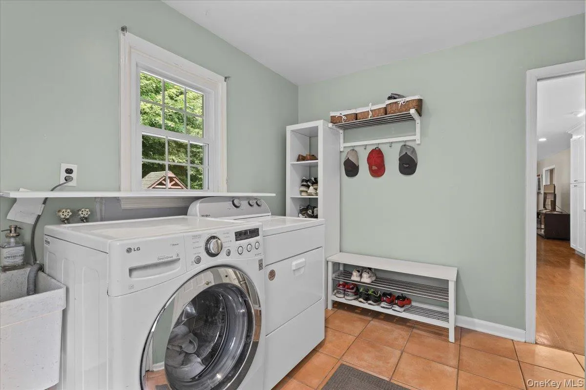 Laundry and mudroom area with side door entry. Laundry and mudroom area with side door entry.