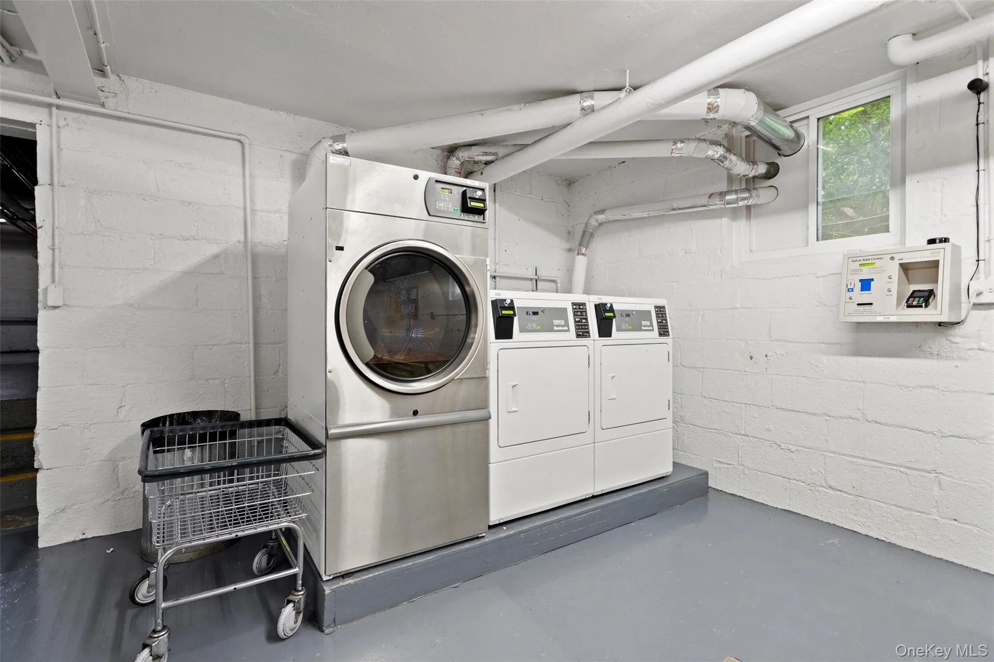 Laundry facility featuring multiple commercial-grade washing machines and dryers. Laundry facility featuring multiple commercial-grade washing machines and dryers.