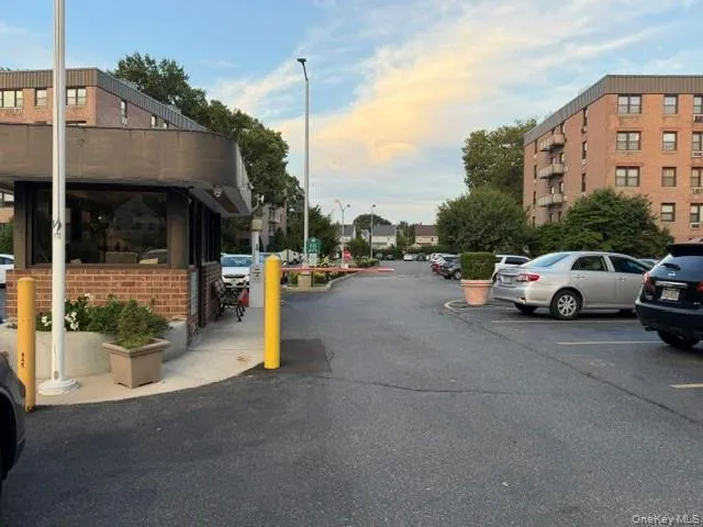 Brick-clad security booth with large windows and integrated landscaping Brick-clad security booth with large windows and integrated landscaping