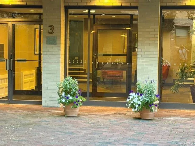 Brick paver walkway with a light-colored brick exterior Brick paver walkway with a light-colored brick exterior