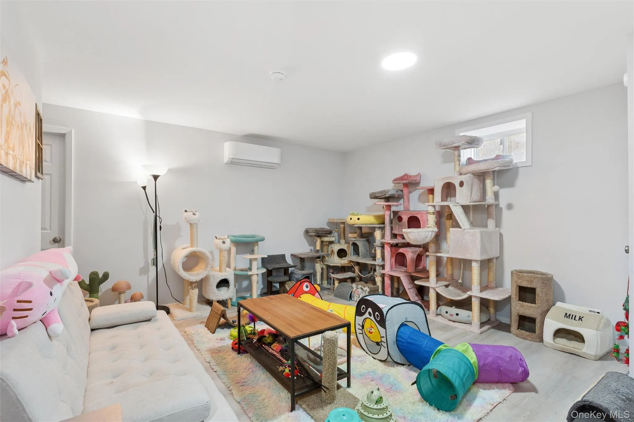 Recessed ceiling lighting, light gray walls, white trim, and wood-finish flooring Recessed ceiling lighting, light gray walls, white trim, and wood-finish flooring