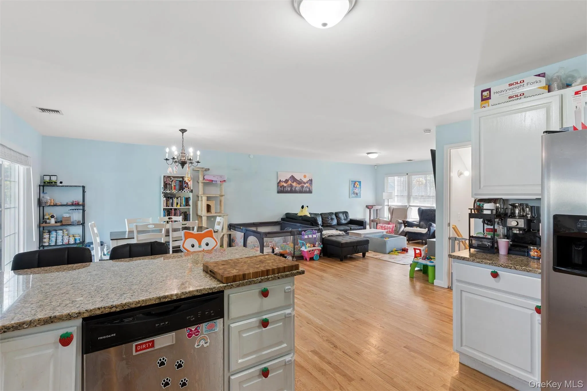 Kitchen island with a light-toned countertop and integrated dishwasher Kitchen island with a light-toned countertop and integrated dishwasher