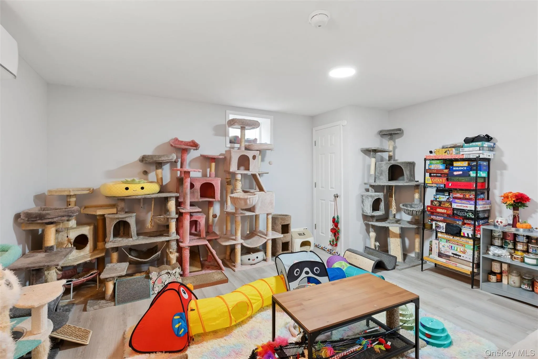Recessed ceiling lighting, light gray walls, white trim, and wood-finish flooring Recessed ceiling lighting, light gray walls, white trim, and wood-finish flooring