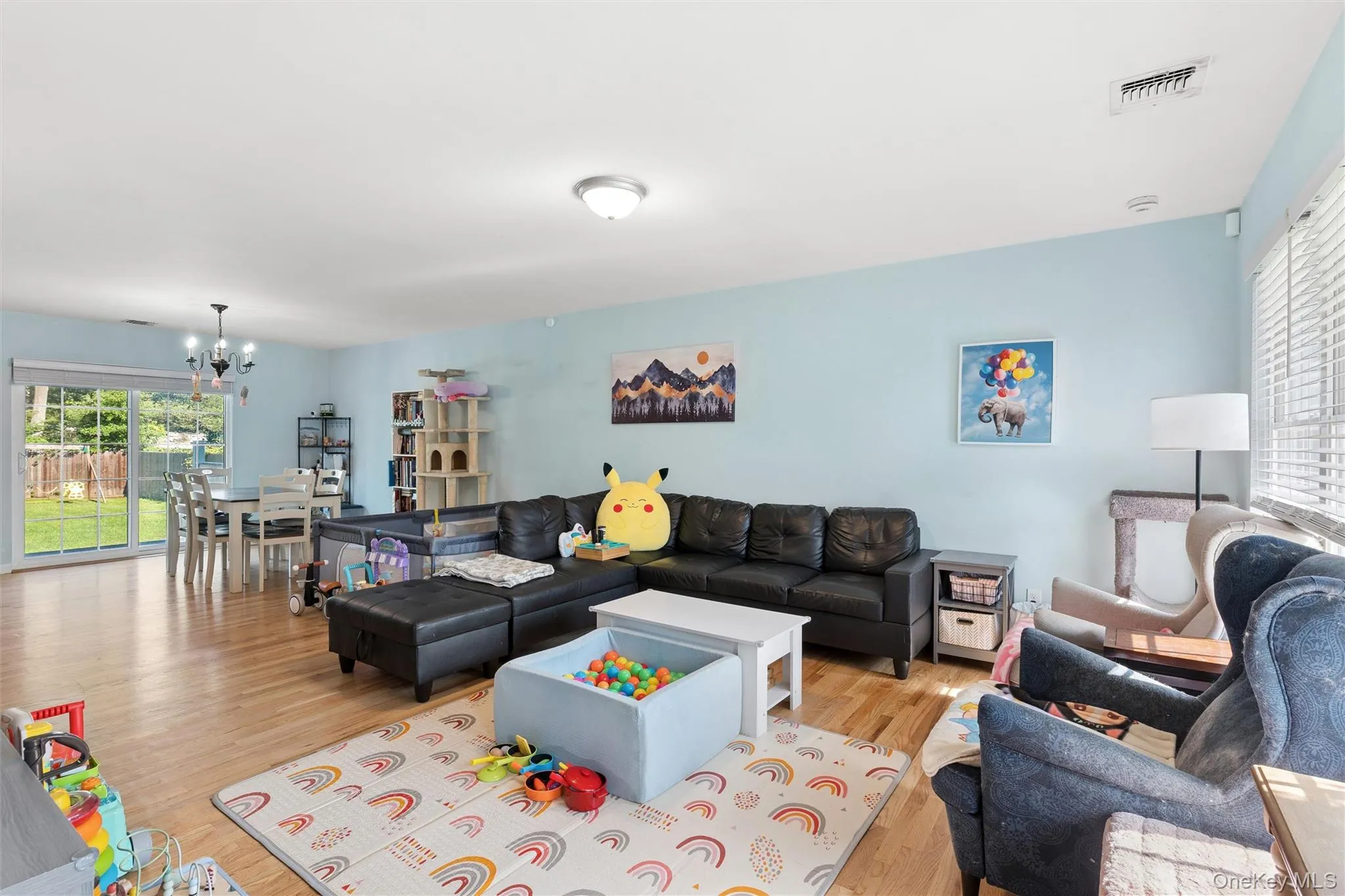 Open-concept living space with wood-finish flooring Open-concept living space with wood-finish flooring