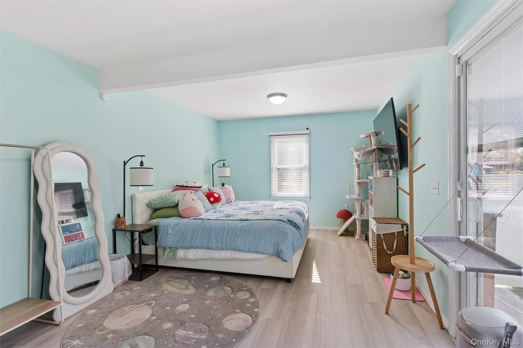 Light wood-finish flooring, recessed lighting, and a white ceiling beam Light wood-finish flooring, recessed lighting, and a white ceiling beam