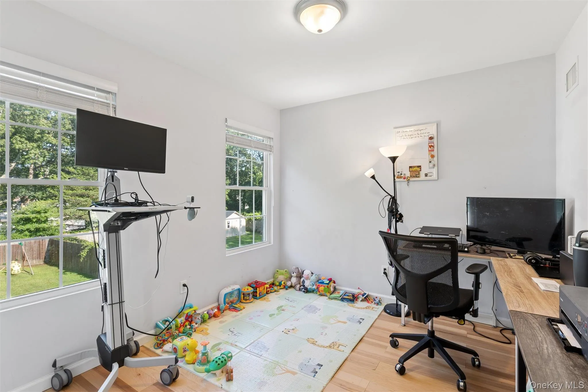 Hardwood-finish flooring, two window units, and ceiling-mounted lighting fixture Hardwood-finish flooring, two window units, and ceiling-mounted lighting fixture