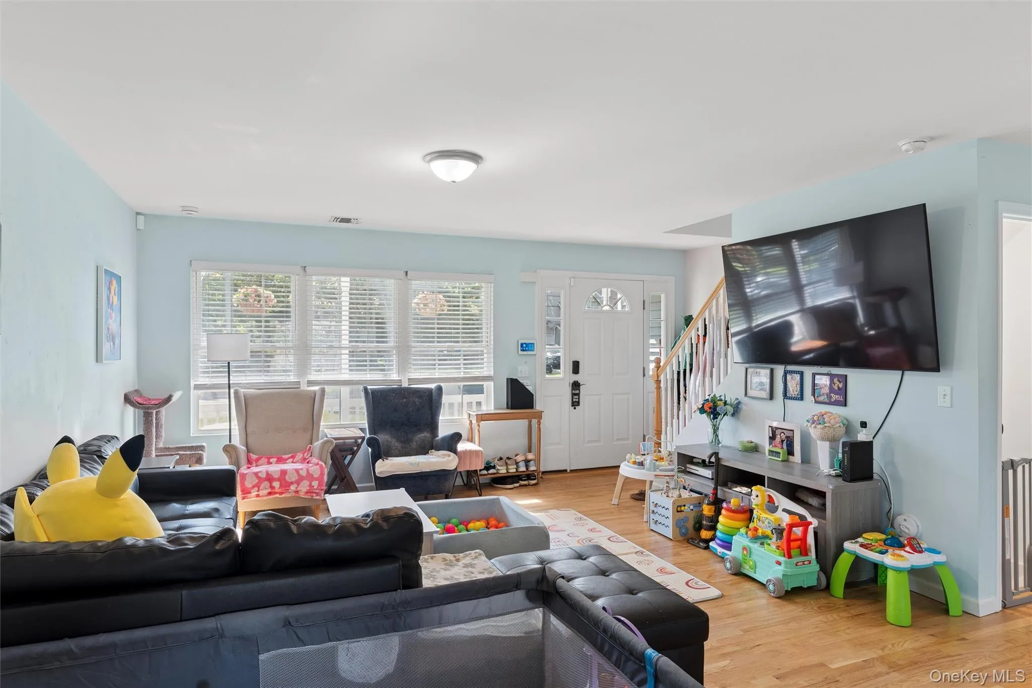 Hardwood-finish flooring, white trim details, and a light-colored interior paint scheme Hardwood-finish flooring, white trim details, and a light-colored interior paint scheme