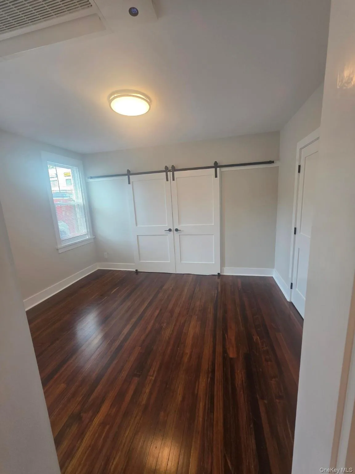 Living room with barn bedroom doors closed Living room with barn bedroom doors closed