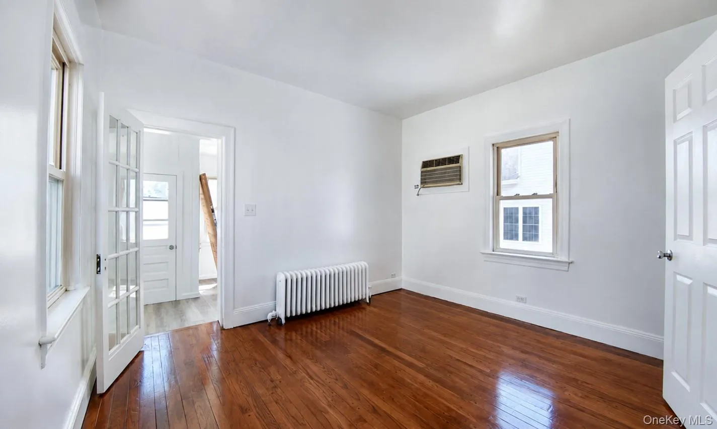 Bedroom 2 with door leading to small sunroom and exit Bedroom 2 with door leading to small sunroom and exit