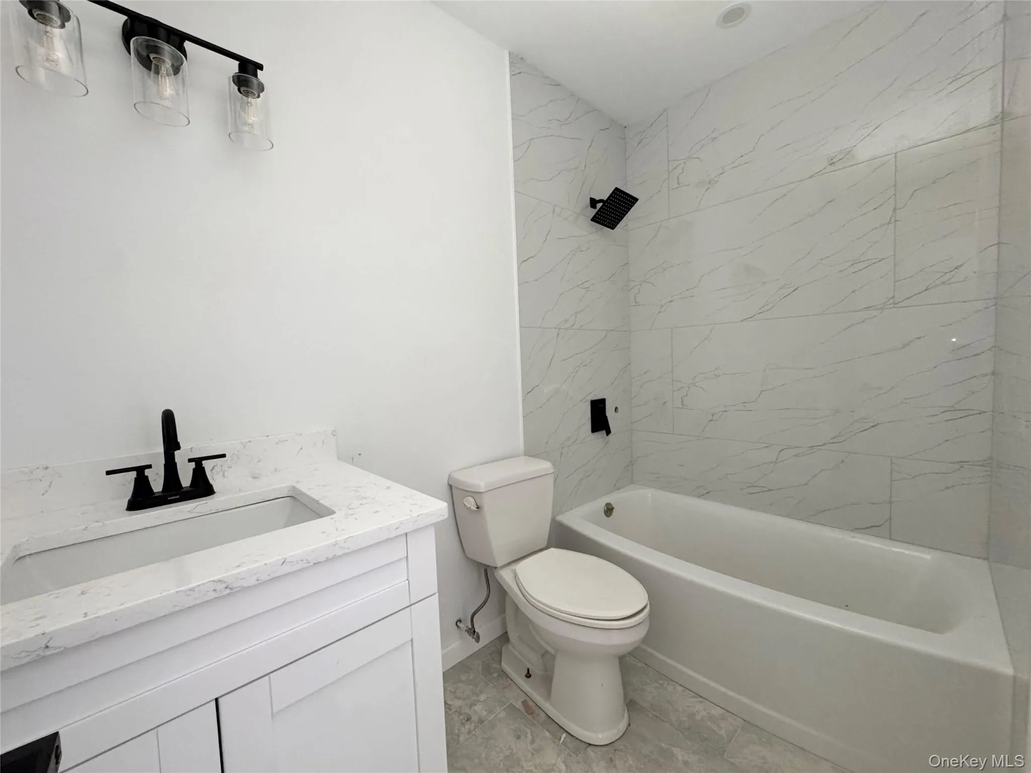 Bathroom featuring a sink with vanity and bathtub with shower Bathroom featuring a sink with vanity and bathtub with shower