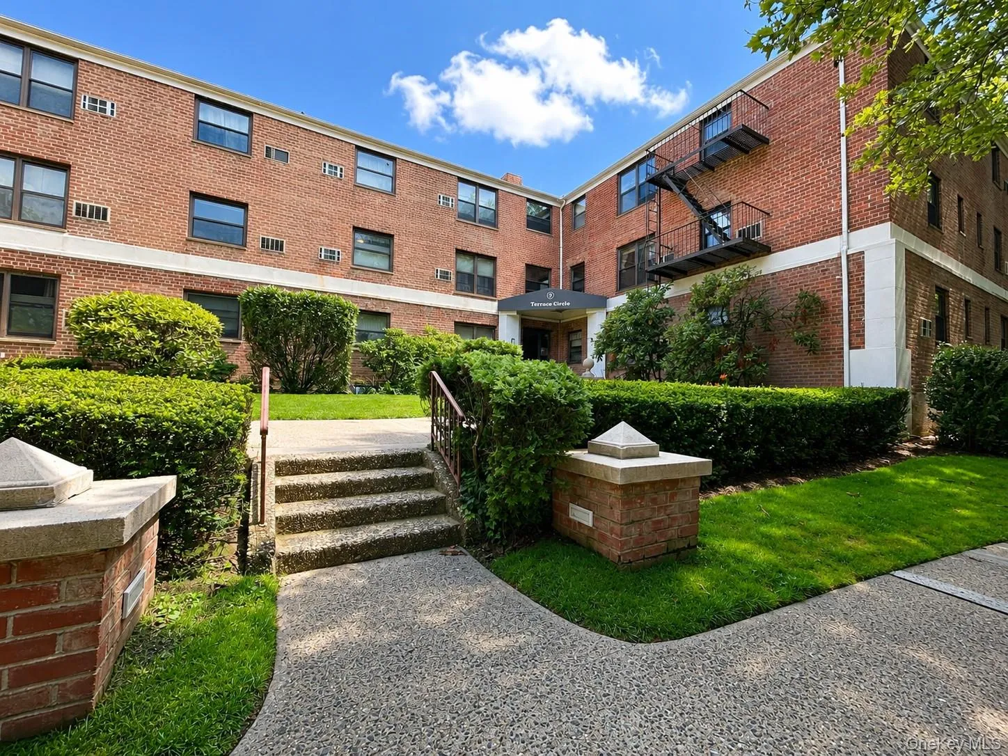 Brick exterior, well-defined landscaping, concrete pathway, exterior staircase, secured entry Brick exterior, well-defined landscaping, concrete pathway, exterior staircase, secured entry