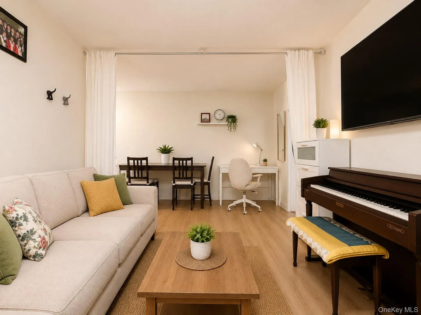Open-concept living area with wood-finish flooring, a dedicated dining space, and a built-in desk area Open-concept living area with wood-finish flooring, a dedicated dining space, and a built-in desk area