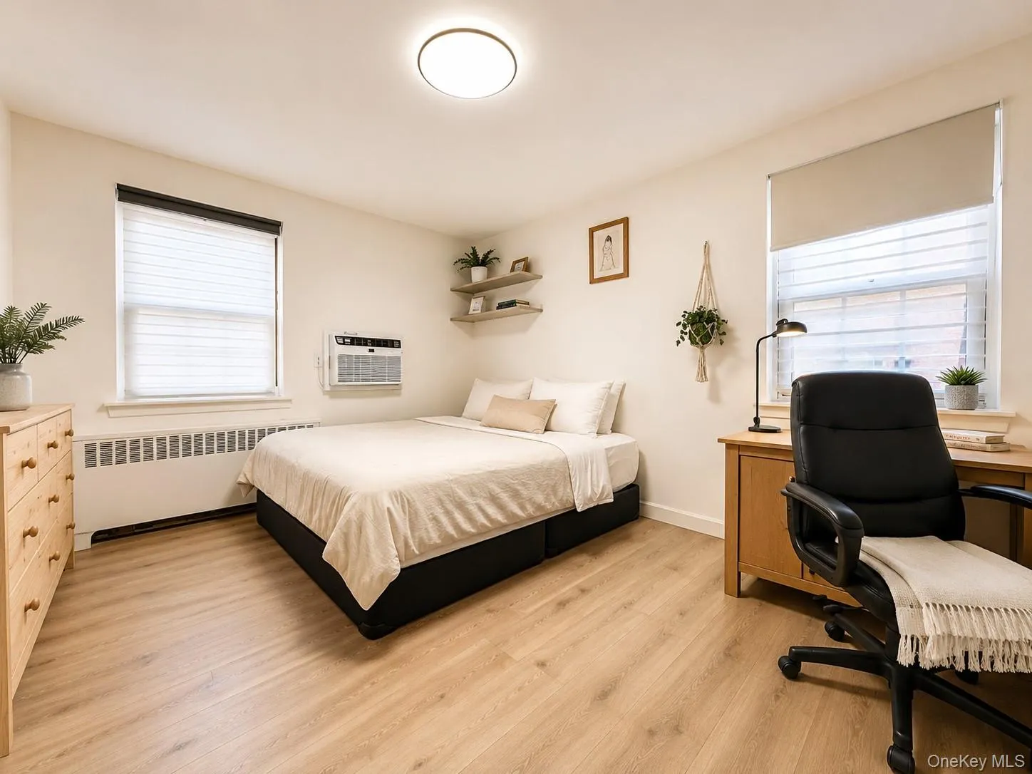 Recessed lighting, wood-finish flooring, two windows with blinds, built-in wall shelves, and an air conditioning unit Recessed lighting, wood-finish flooring, two windows with blinds, built-in wall shelves, and an air conditioning unit