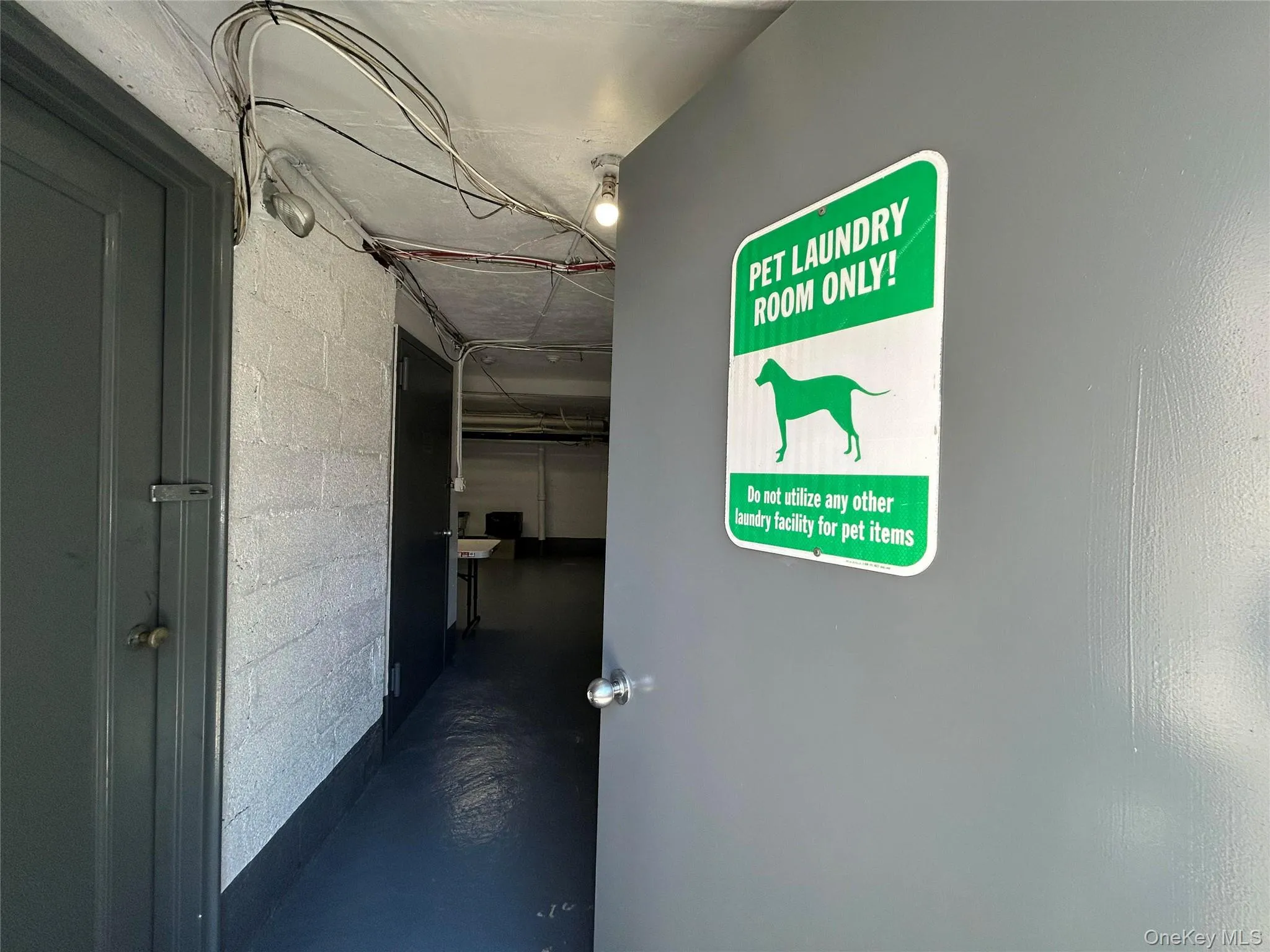 Dedicated pet laundry room with a clear informational sign Dedicated pet laundry room with a clear informational sign