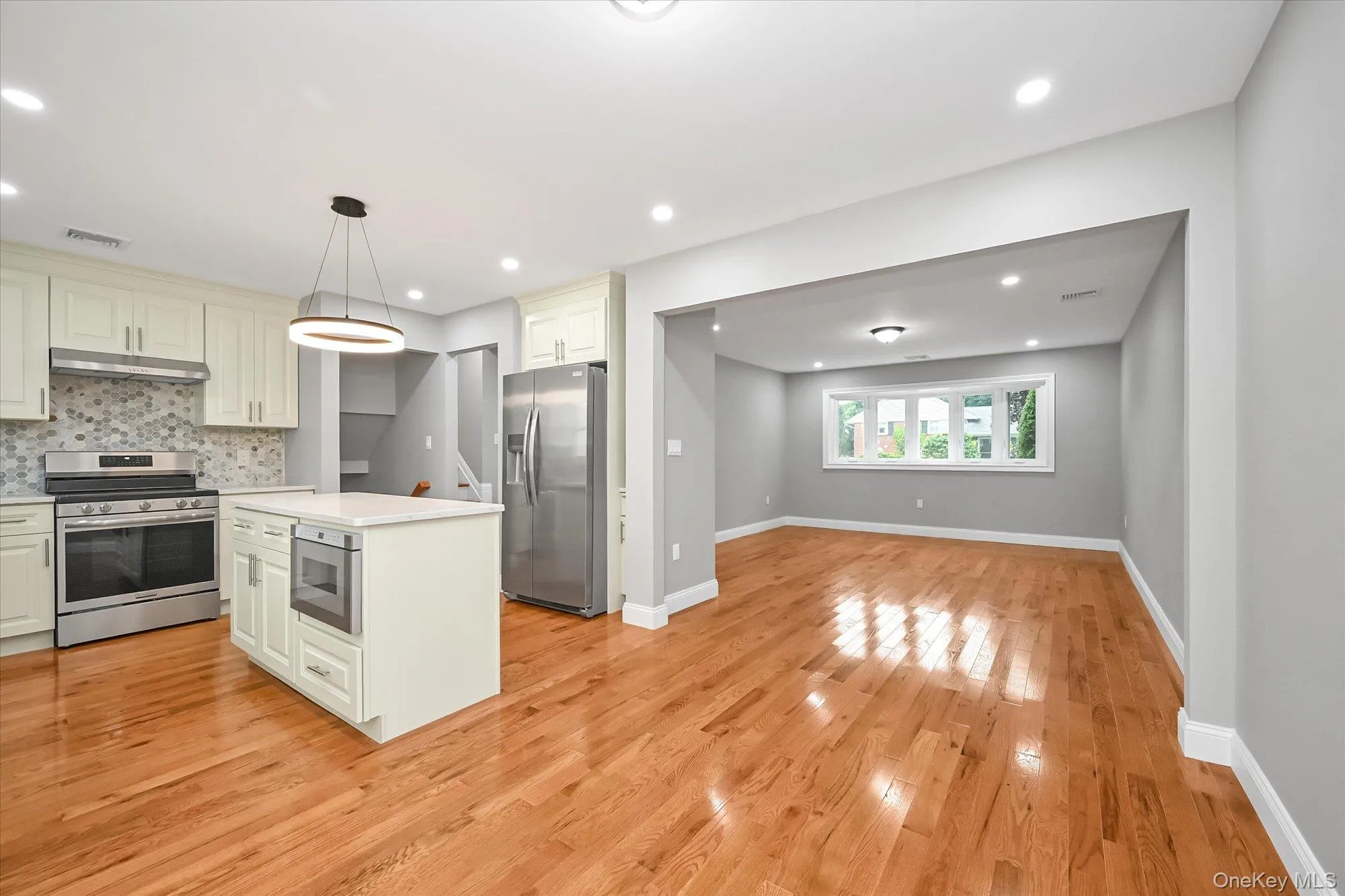 Living Room - Open Floor-Plan to Dining Room and Kitchen Living Room - Open Floor-Plan to Dining Room and Kitchen