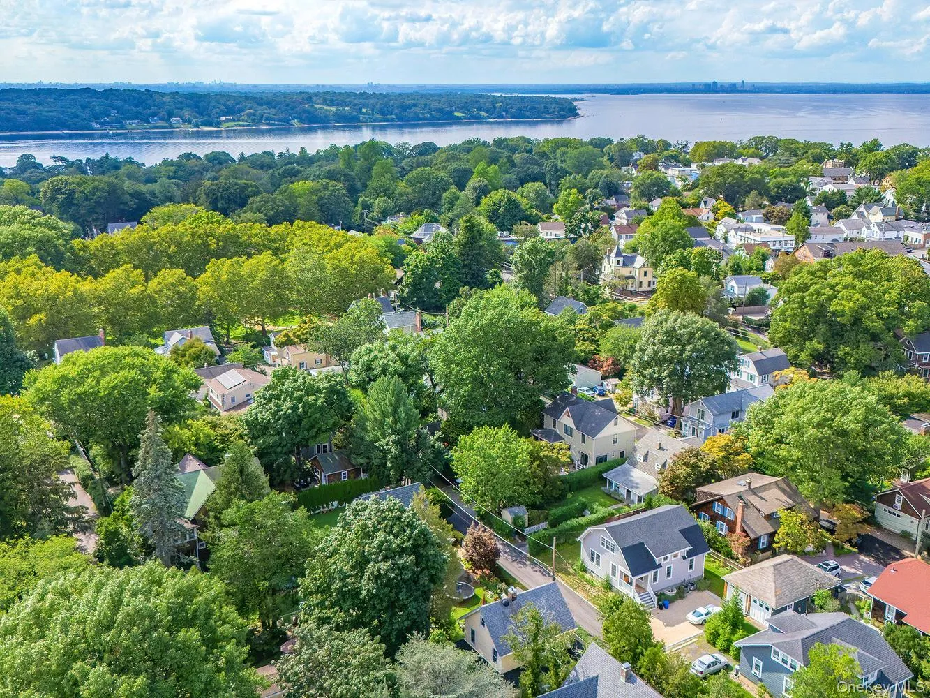 Sea Cliff's one square mile from above. A patchwork of tree-lined streets and historic homes rolling toward the water Sea Cliff's one square mile from above. A patchwork of tree-lined streets and historic homes rolling toward the water