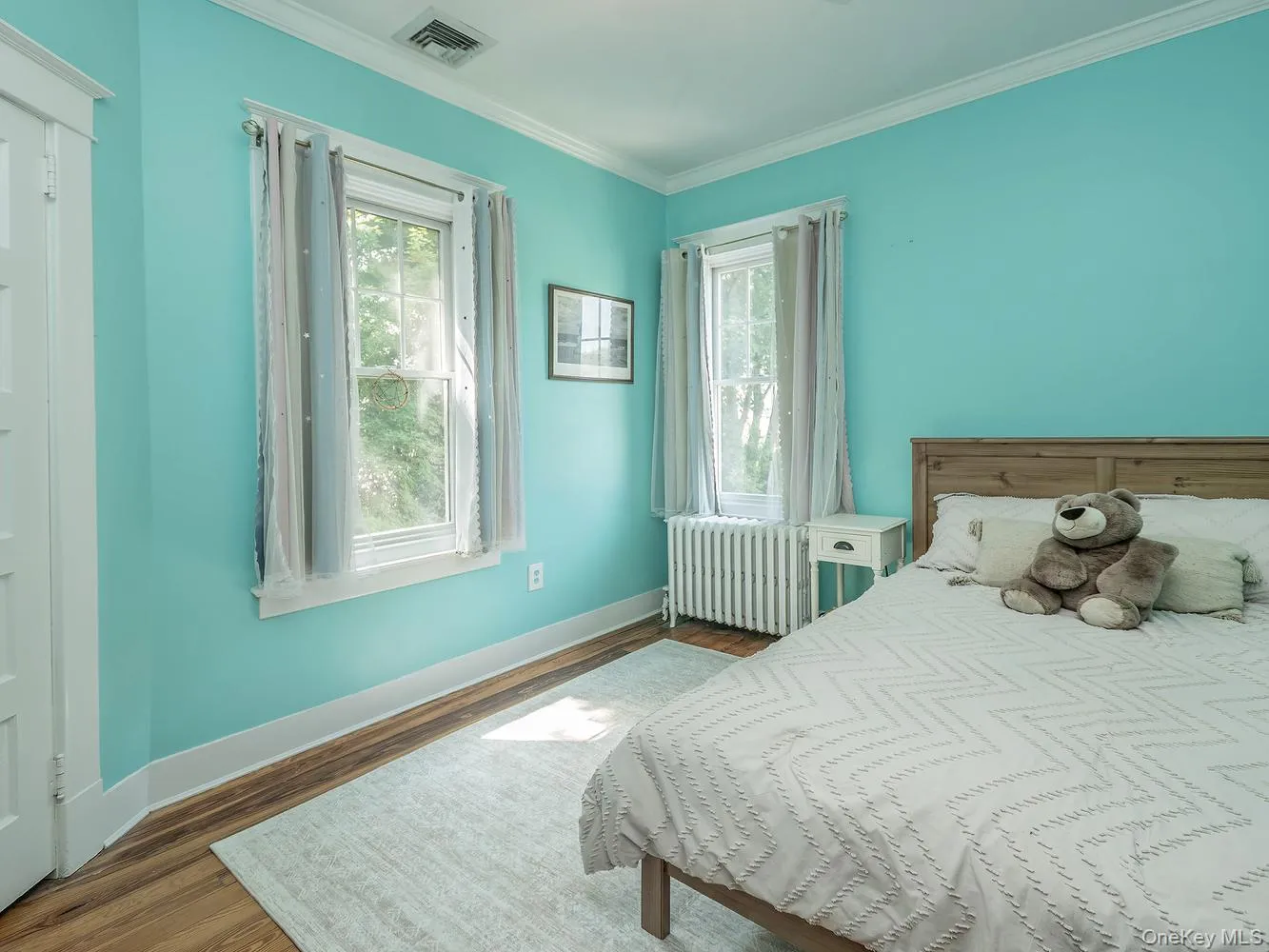 Bedroom #1 features warm wood floors, soaring ceilings, and elegant crown moldings Bedroom #1 features warm wood floors, soaring ceilings, and elegant crown moldings