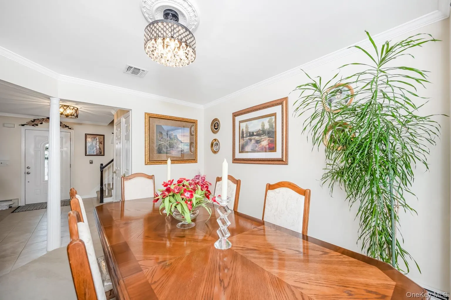 Recessed lighting, crown molding, and a chandelier with a ceiling medallion Recessed lighting, crown molding, and a chandelier with a ceiling medallion