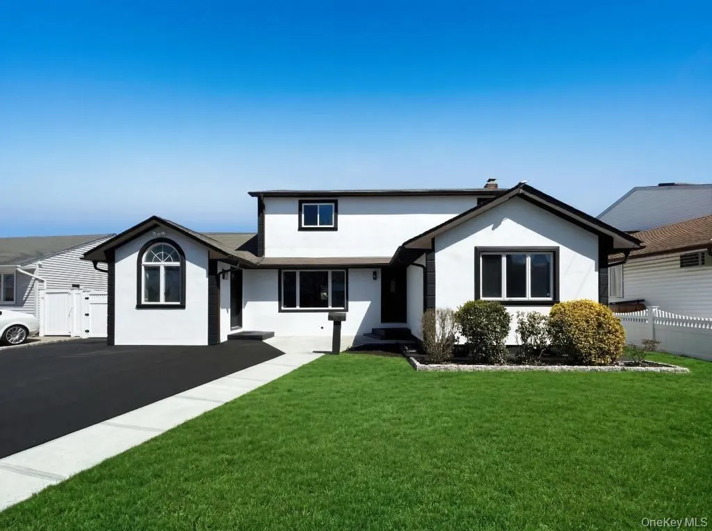 White stucco exterior with contrasting black trim White stucco exterior with contrasting black trim