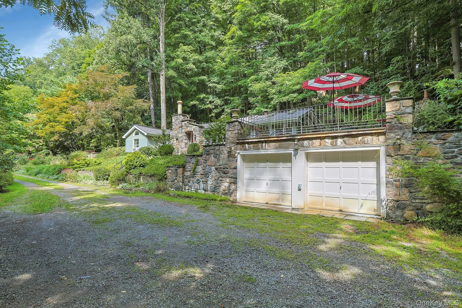 The garage is tucked under the terraced patio, unobtrusive in the hillside. Tenants have use of the space on the right. The garage is tucked under the terraced patio, unobtrusive in the hillside. Tenants have use of the space on the right.
