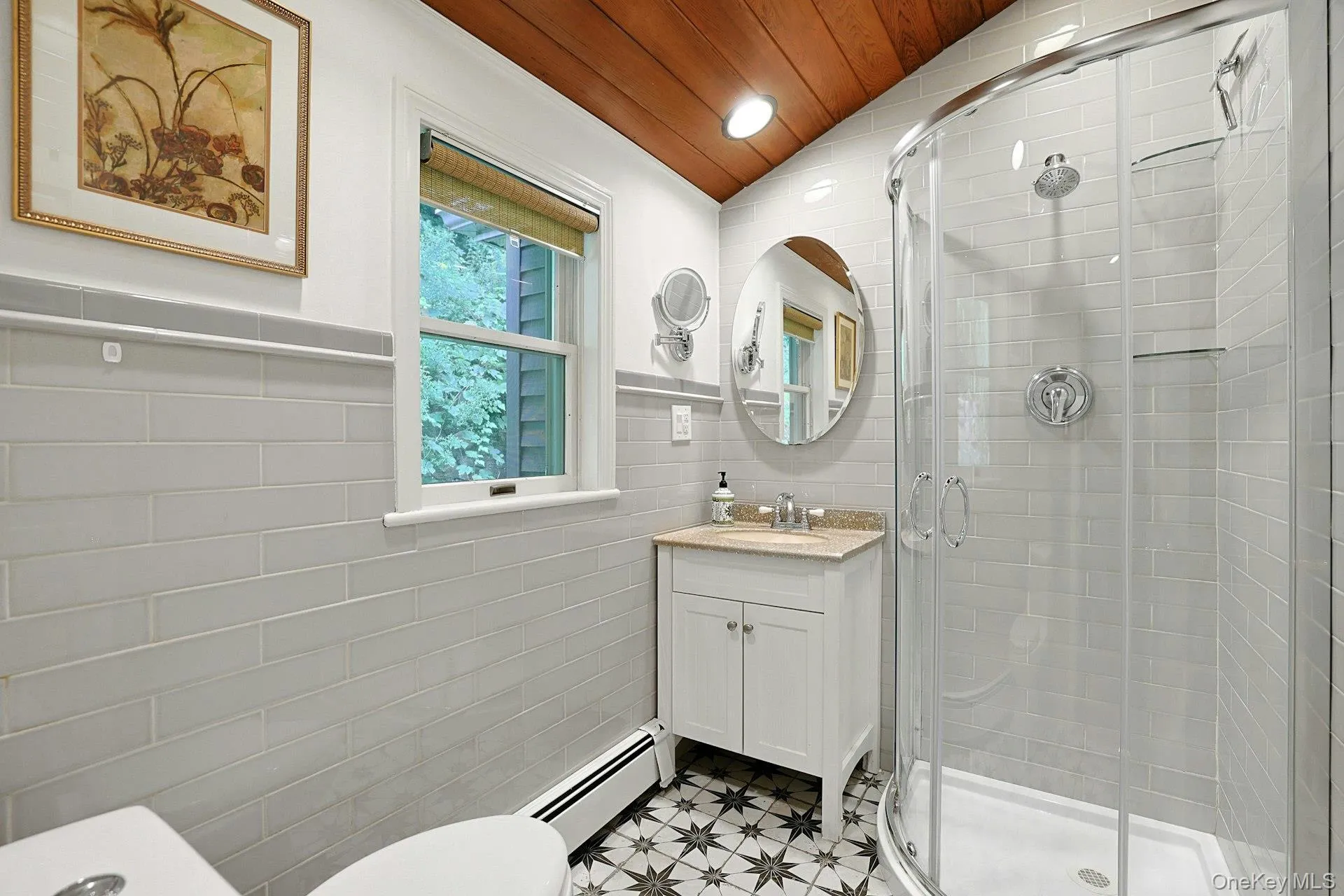 A fully modern space with a tiled showed, unique floor and rising ceiling. A fully modern space with a tiled showed, unique floor and rising ceiling.