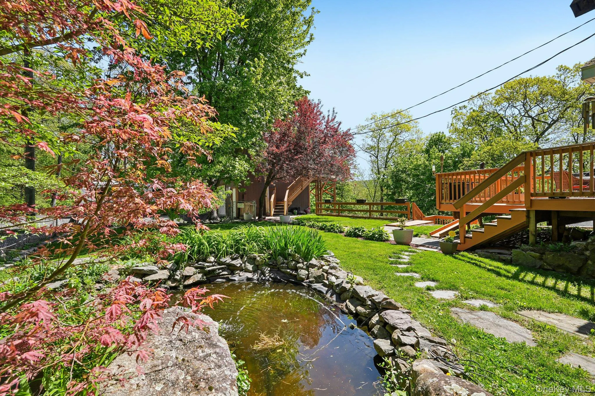 View of pond, gardens and trees. View of pond, gardens and trees.