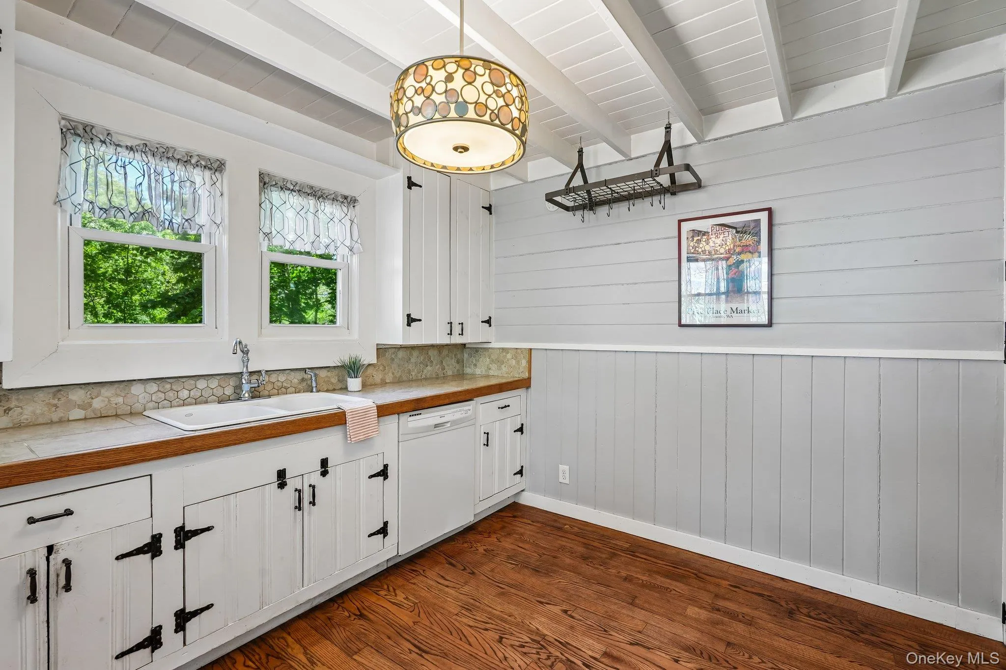 Quaint kitchen with lots of light, marble tile countertops, & architectural ceiling. Quaint kitchen with lots of light, marble tile countertops, & architectural ceiling.