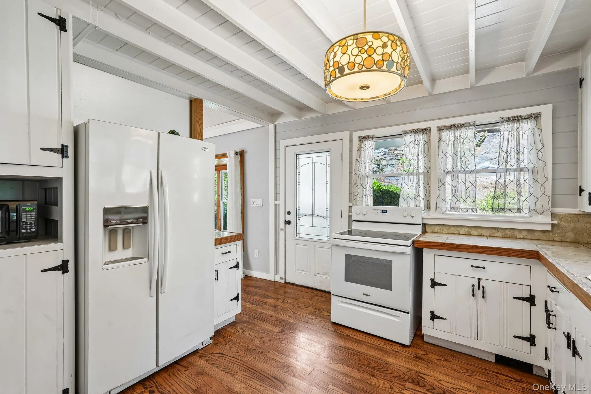 Kitchen in house 2. Refrigerater, hardwood floors, cabinetry. Kitchen in house 2. Refrigerater, hardwood floors, cabinetry.