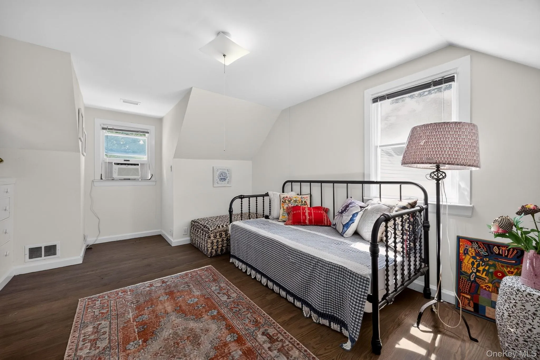 Wood-finish flooring, white walls, and a ceiling-mounted light fixture Wood-finish flooring, white walls, and a ceiling-mounted light fixture