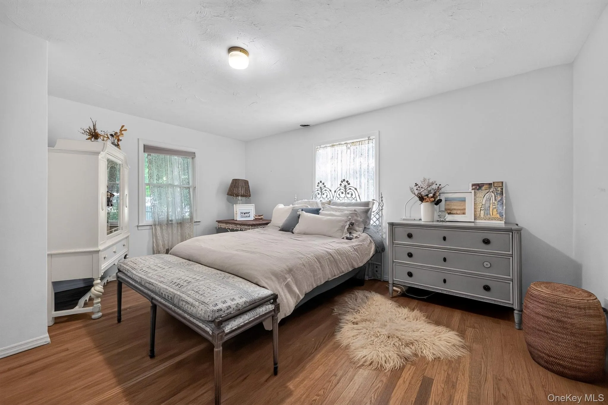 Hardwood flooring, painted walls, ceiling-mounted lighting fixture, and window with trim Hardwood flooring, painted walls, ceiling-mounted lighting fixture, and window with trim