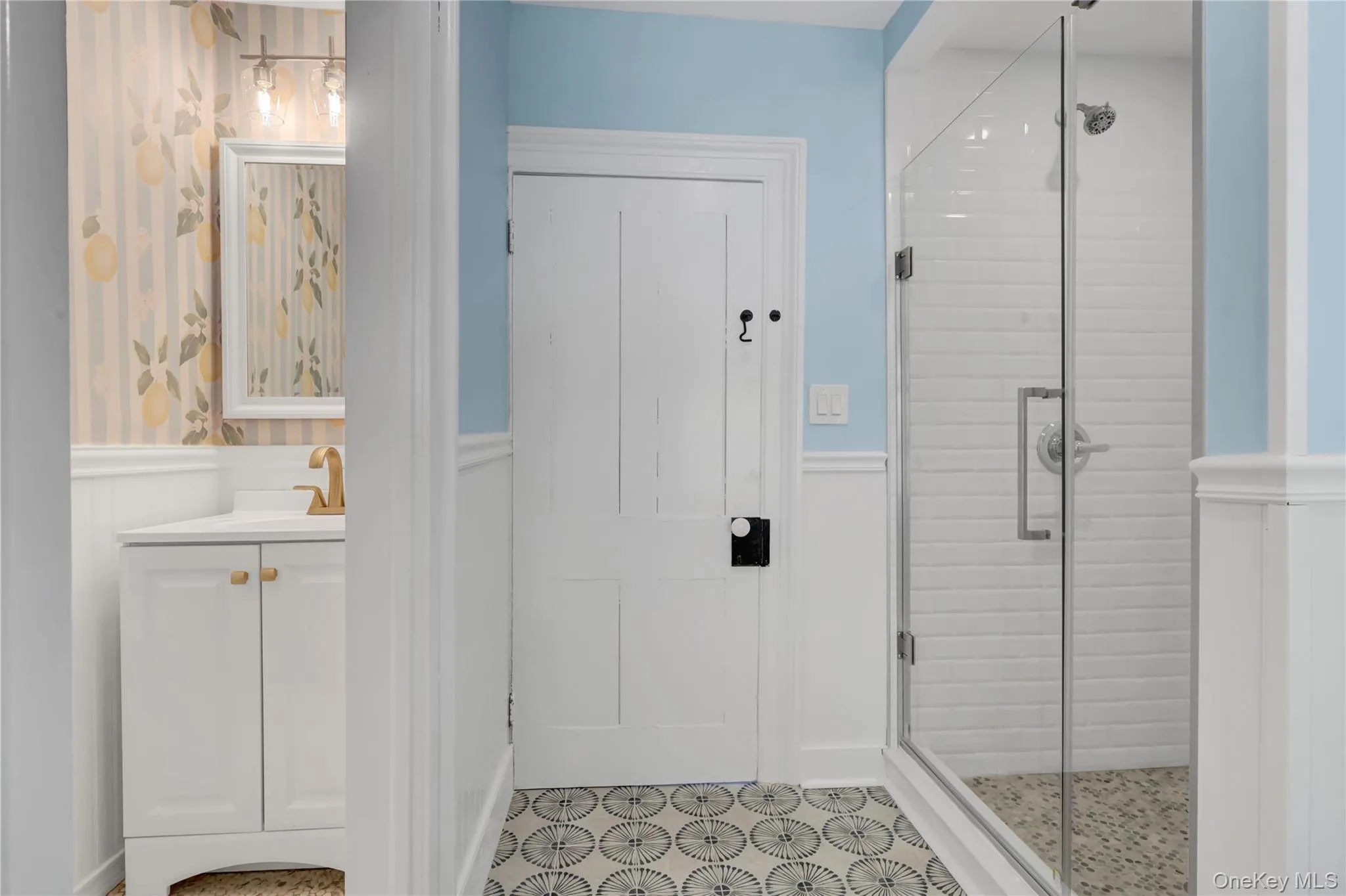 Full bathroom featuring a shower stall, vanity, and wainscoting Full bathroom featuring a shower stall, vanity, and wainscoting