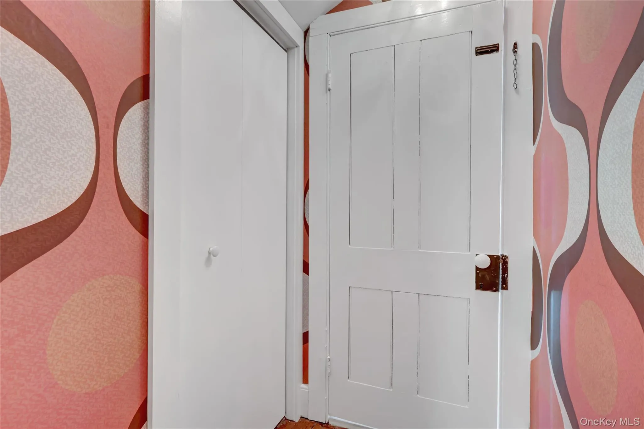 Doorway featuring wallpapered walls Doorway featuring wallpapered walls