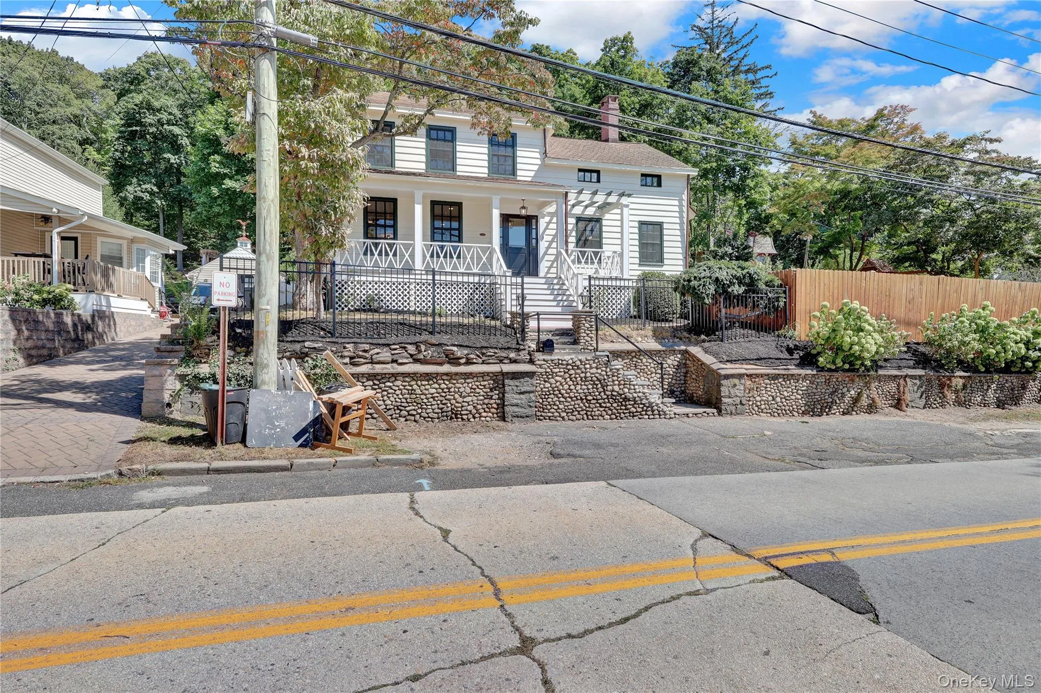 View of front of house featuring a porch and a chimney View of front of house featuring a porch and a chimney