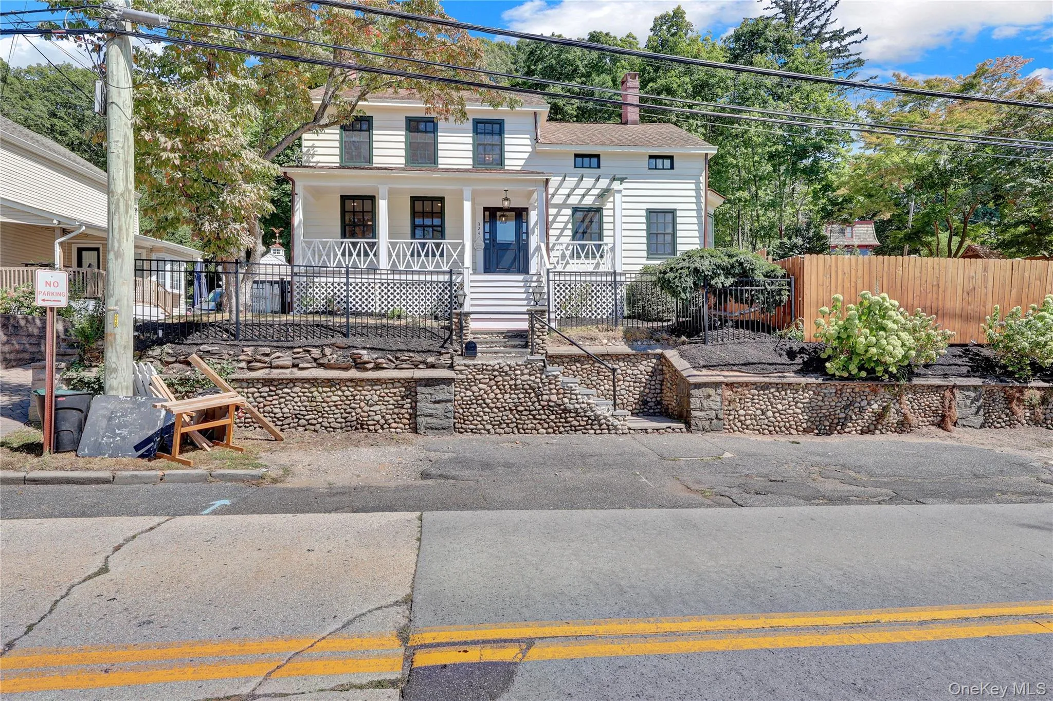 View of front of home featuring a porch and a chimney View of front of home featuring a porch and a chimney
