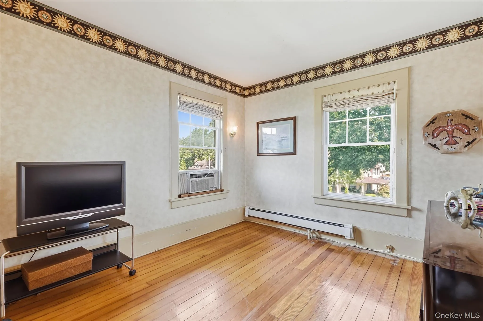 Charming bedroom offers character, comfort, and abundant natural light Charming bedroom offers character, comfort, and abundant natural light