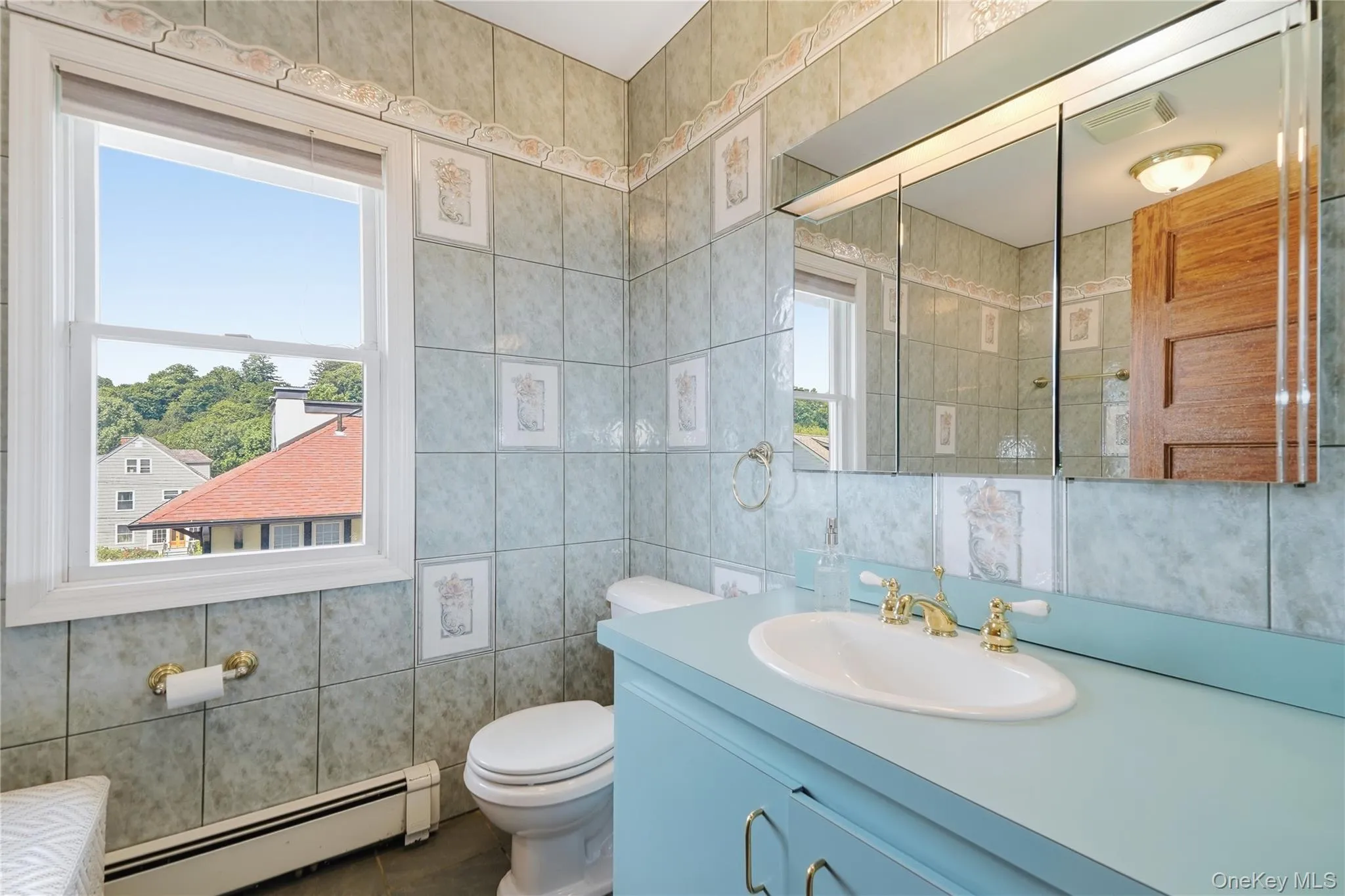 Bright full bathroom offers generous storage and natural light Bright full bathroom offers generous storage and natural light