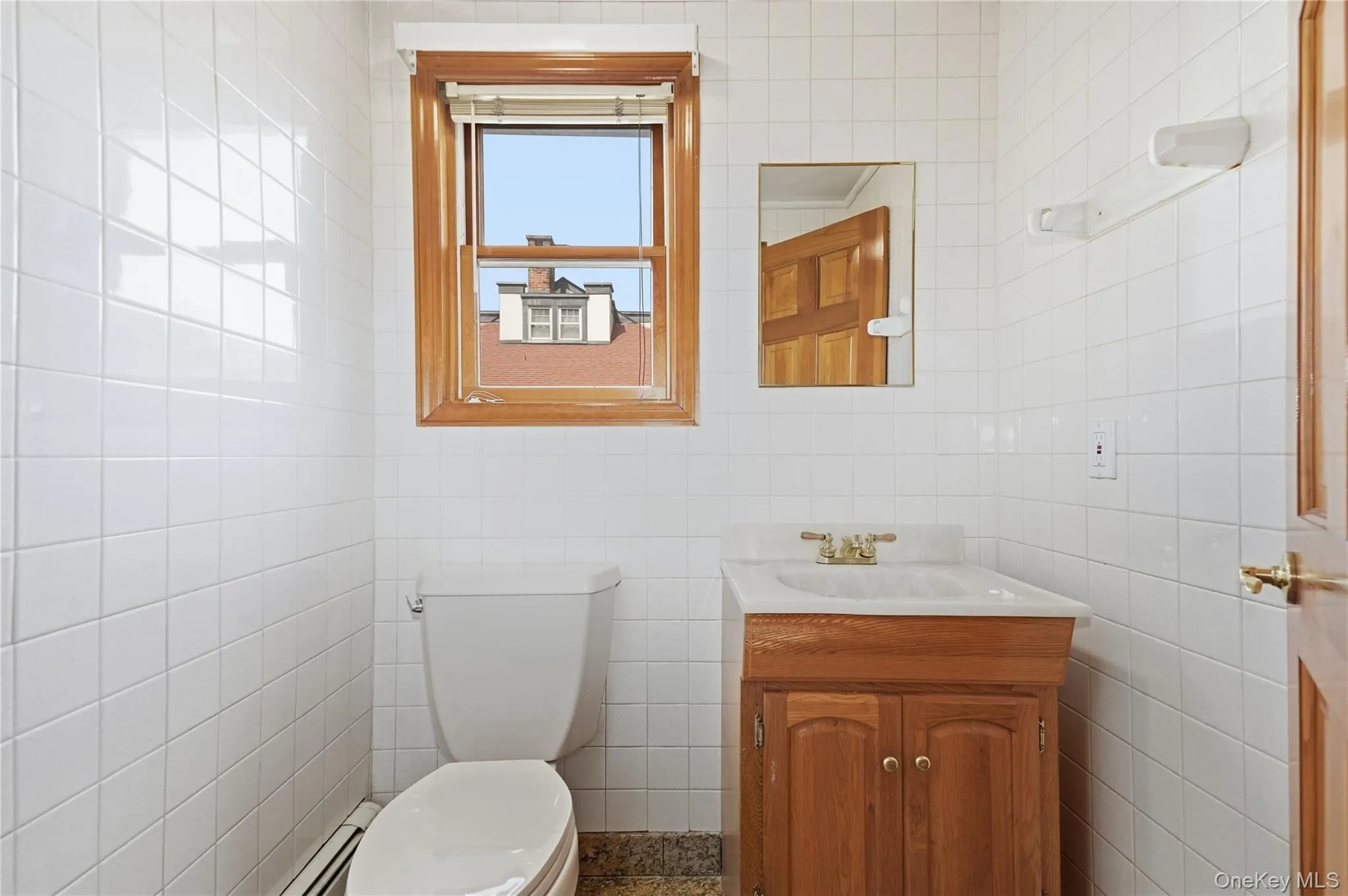 Bright bathroom offers classic tile and natural light Bright bathroom offers classic tile and natural light