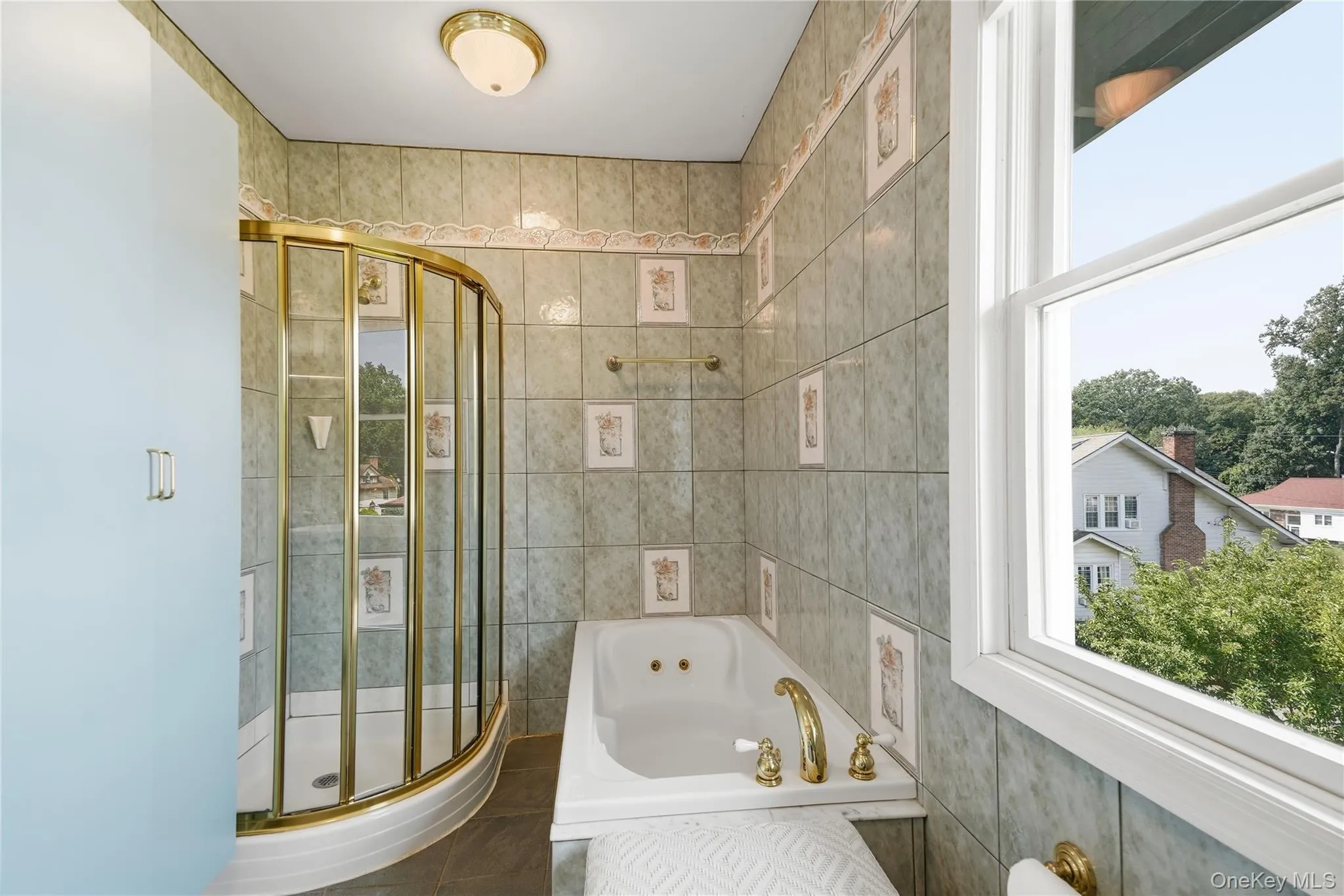 Primary bathroom features soaking tub, shower, and scenic views Primary bathroom features soaking tub, shower, and scenic views