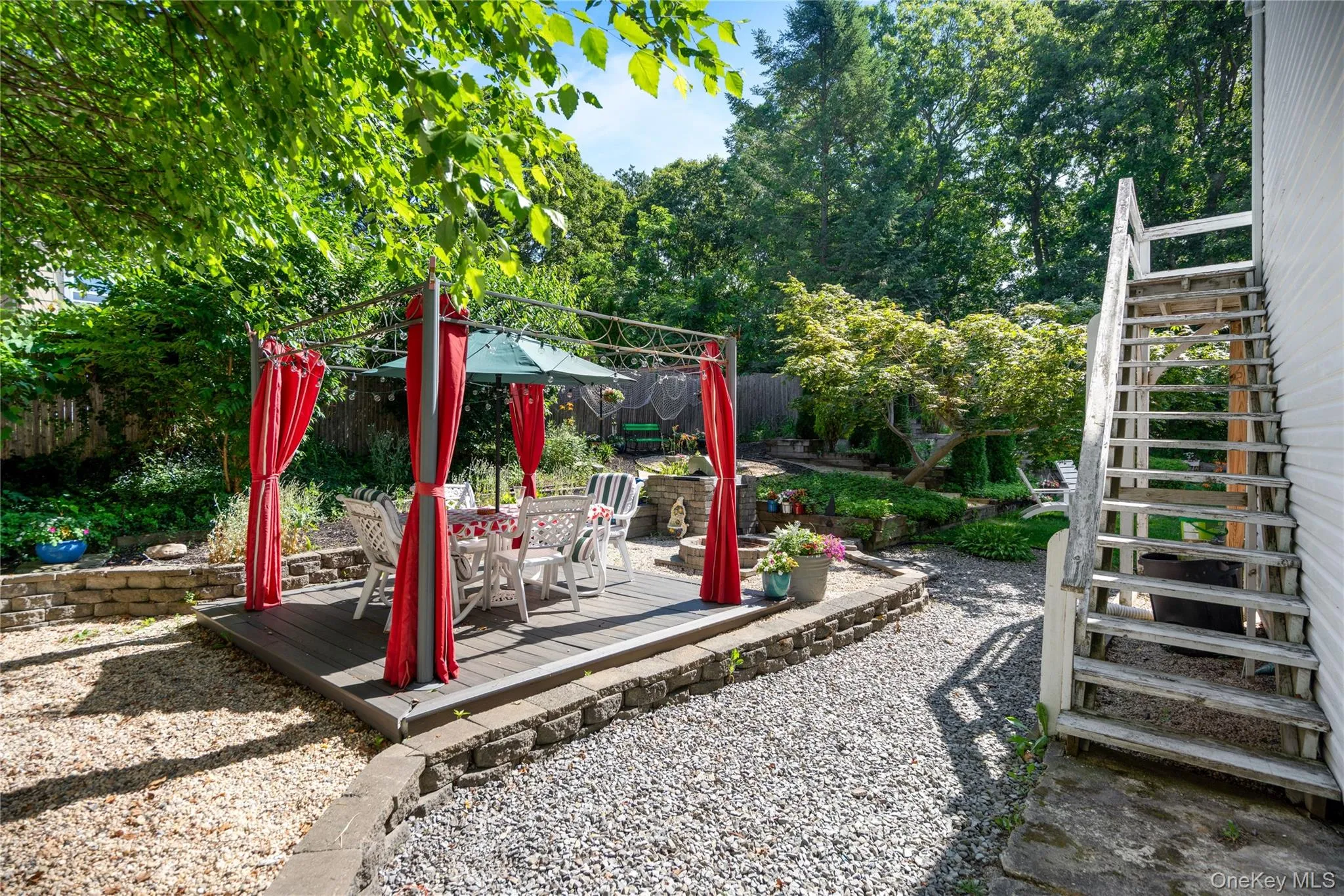 12' x 12' platform structure featuring a stone built-in BBQ and a custom fire pit. 12' x 12' platform structure featuring a stone built-in BBQ and a custom fire pit.