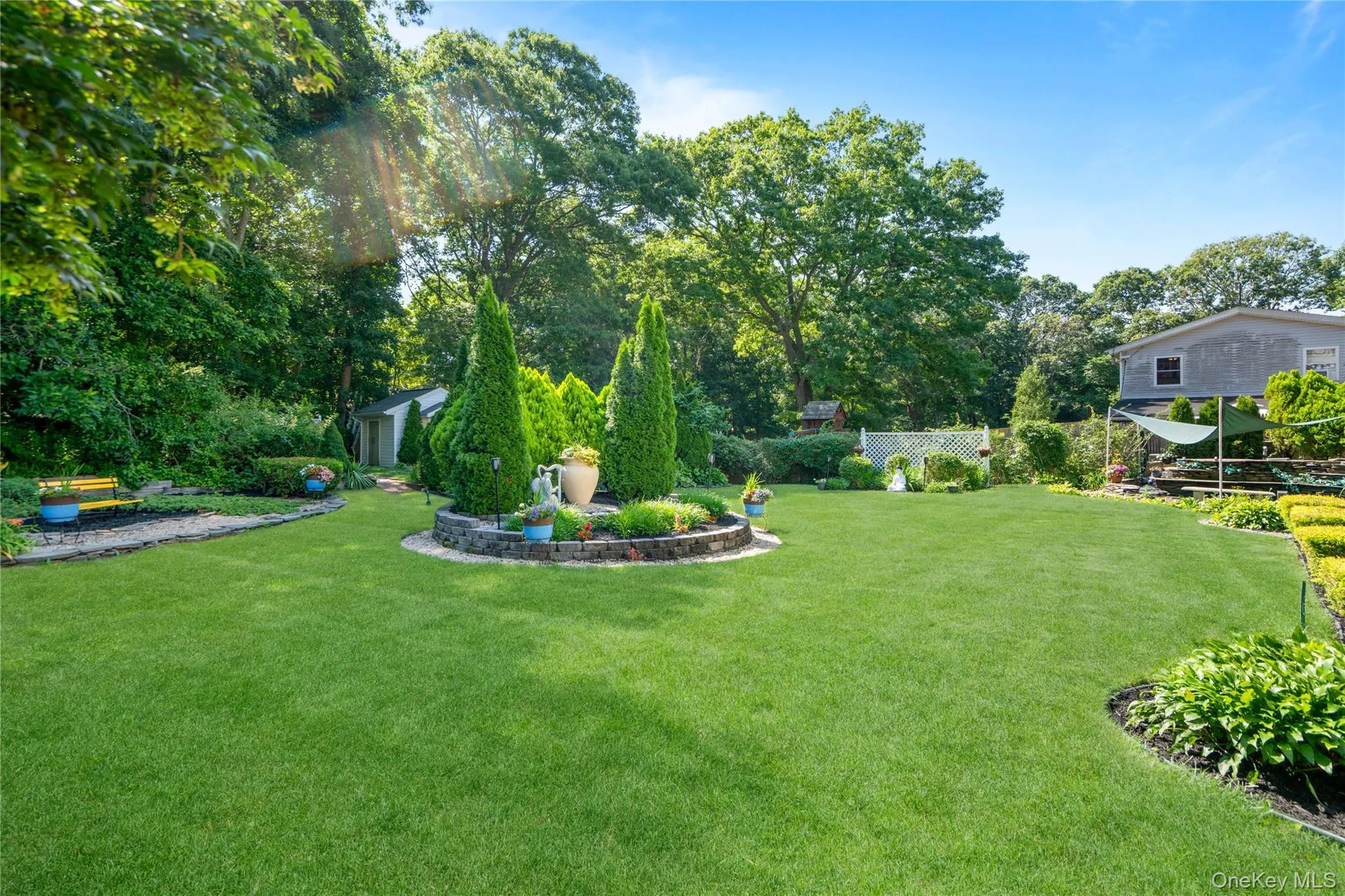 Circular garden bed filled with a variety of vibrant perennial flowers. Circular garden bed filled with a variety of vibrant perennial flowers.